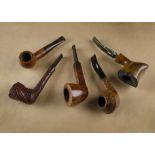 A collection of five G.W.Sims briar estate pipes, including a London Made Special sitter, straight