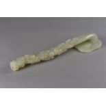 A late 19th Century Chinese green hardstone sceptre, the naturalistic carved staff supporting a