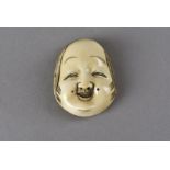 A Meiji period signed Japanese signed ivory netsuke, modelled as a female noh theatre mask, depicted