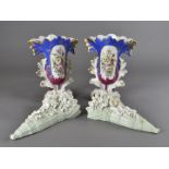 A pair of continental porcelain spill vases, with central oval panel filled with floral spray