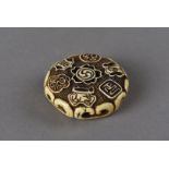 A Meiji period signed Japanese ivory ryusa netsuke, of circular design with pierced decoration of