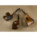 Three G.W. Sims freehand briar estate pipes, all with thumb rests, two with rusticated plateau rims,