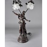 A continental figural table lamp, modelled as an art nouveau maiden supporting two large branches