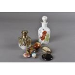 A small collection of novelty scent bottles, in materials including glass, ceramic, mother-of-pearl,