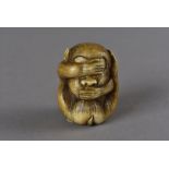 A carved Japanese signed ivory netsuke, modelled as a seated monkey, with its hands over its eyes