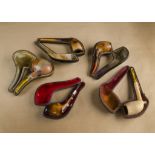A collection of five cased meerschaum pipes, all with plain bowls and having amber mouth pieces (5)