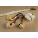Two antique meerschaum pipes, both of bent shape with silver plated collars together with a large