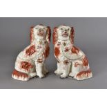 A pair of 19th century Staffordshire chimney dogs, with one front leg modelled away, together with a