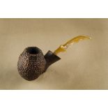 A Robert Vacher Laughingmoon briar estate pipe, the oval sandblasted bowl, with hand carved shank,