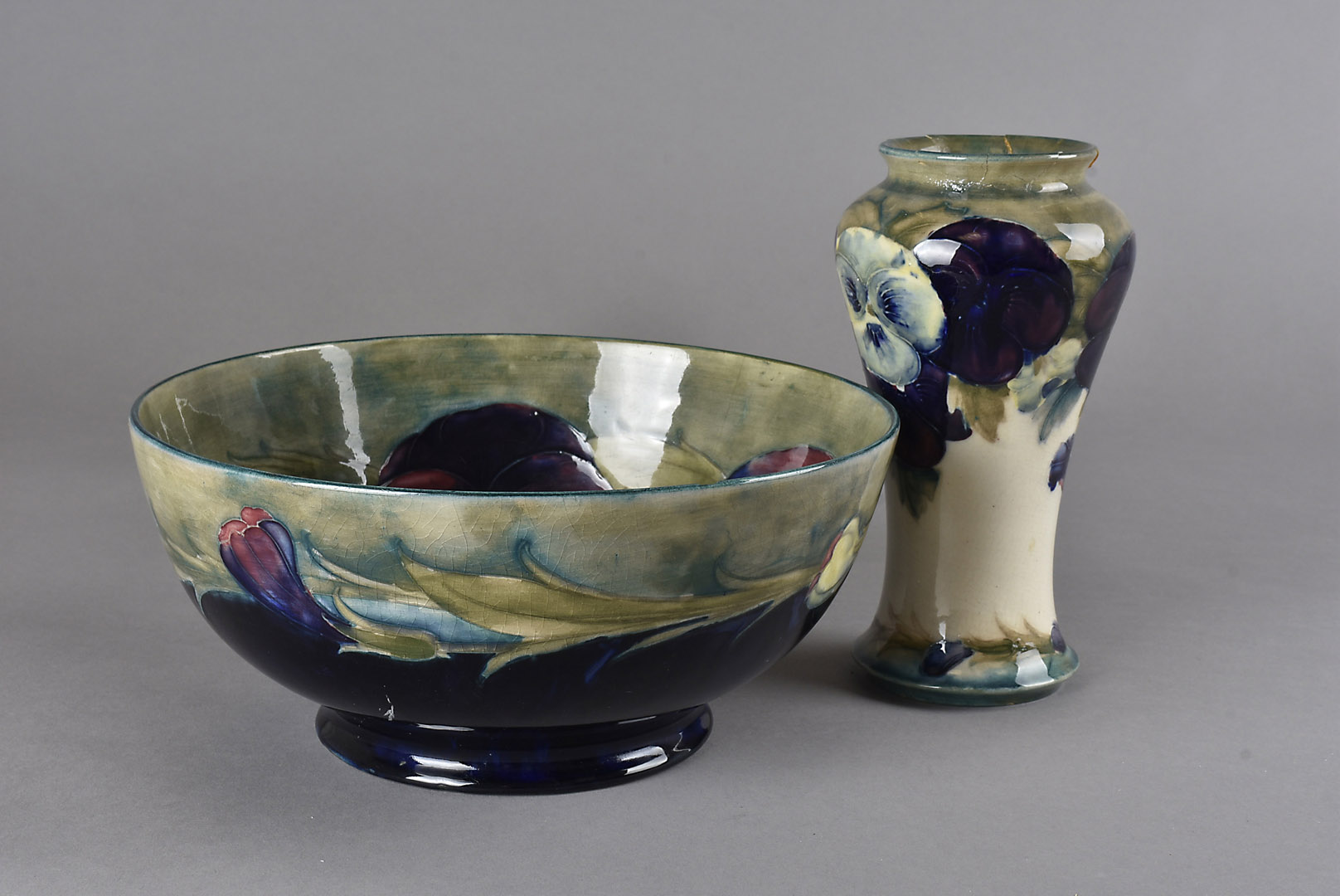 A Moorcroft pottery Pansy bowl, the interior decorated with violet flowers against a green ground,