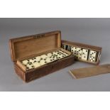 Three 19th Century bone and ebony domino sets, two sets containing twenty eight, one set twenty
