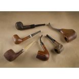 A collection of six briar estate pipes, all unnamed, including a sandblasted with a silver shank,