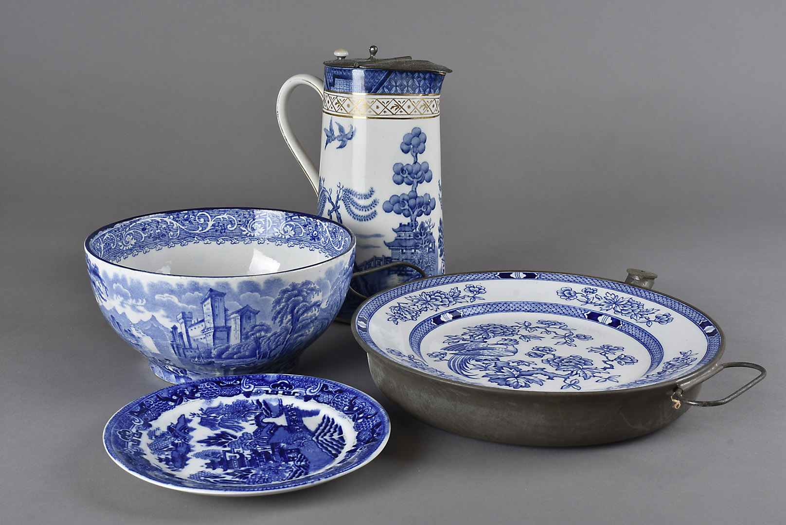 A collection of blue and white English pottery, including a hot plate, meat platter etc