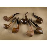 Seven G.W Sims briar estate pipes, comprising two sandblasted, one rusticated, four smooth, each