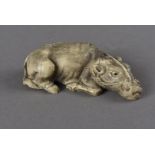 A Meiji period signed Japanese ivory netsuke, modelled as a recumbent water buffalo with rope