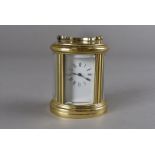 A late 20th Century cylindrical brass carriage timepiece, with white enamel dial, roman numerals,