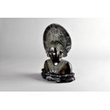 A 20th Century bronze casting of a Balinese woman, in ceremonial headdress and necklace on a