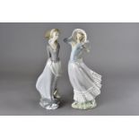 Two large Lladro figures, one as a lady holding onto her bonnet AF, the other with a book clasped