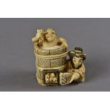 A Meiji period Japanese signed ivory netsuke, modelled as a bather within a coopered barrel being