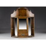 An Edwardian oak and brass smokers cabinet, the corner cabinet with bevelled mirrored backs and