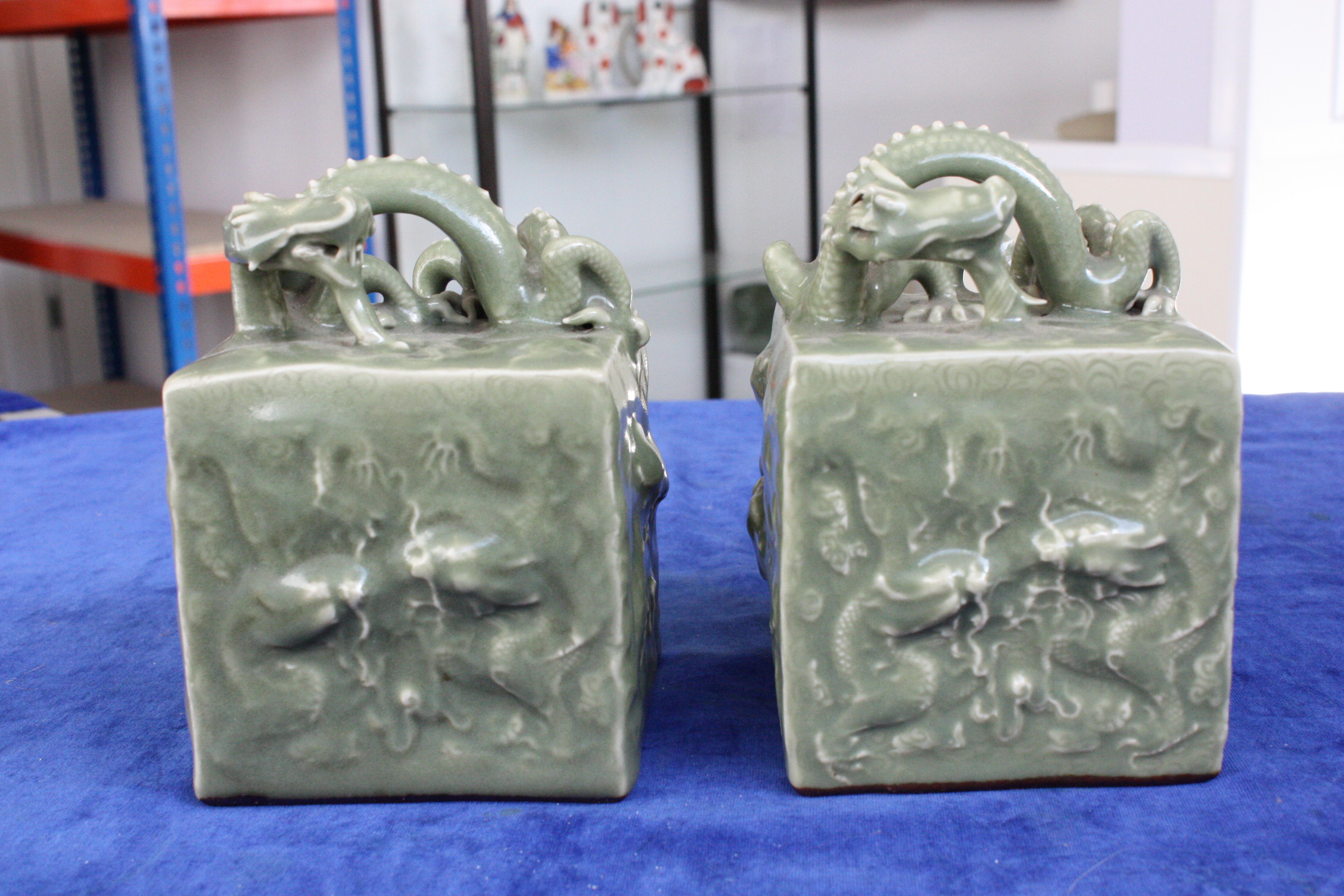 A pair of Chinese celadon glazed scroll weights, with seal marks to underside, decorated with - Image 5 of 7