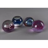 Two Caithness glass limited edition paperweights, plus another two including 'Fireball' and 'Pebble'