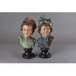 A pair of Victorian polychrome pottery busts, modelled as a girl in a bonnet and a boy with hat,