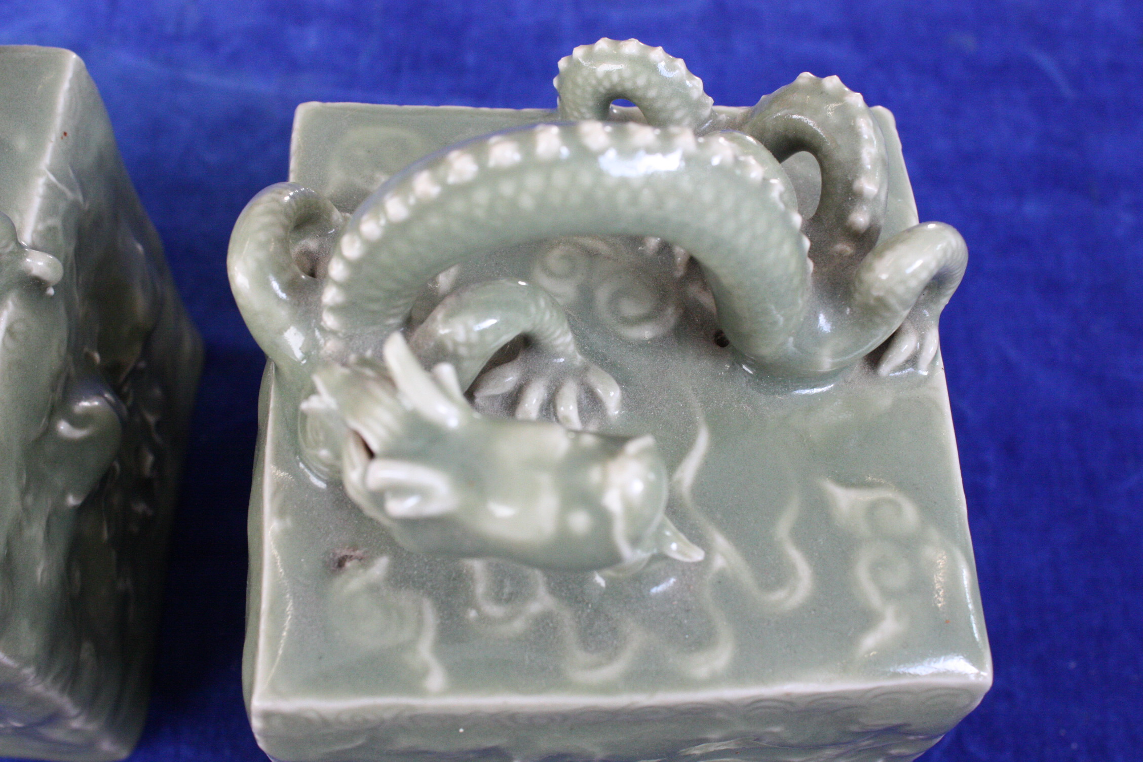 A pair of Chinese celadon glazed scroll weights, with seal marks to underside, decorated with - Image 6 of 7