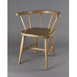 An early to mid-20th century beech child's chair, with elm seat surmounted by a horseshoe spindle
