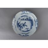 A 17th century delft plate, in the chinoiserie style with centred landscape and floral spray design,