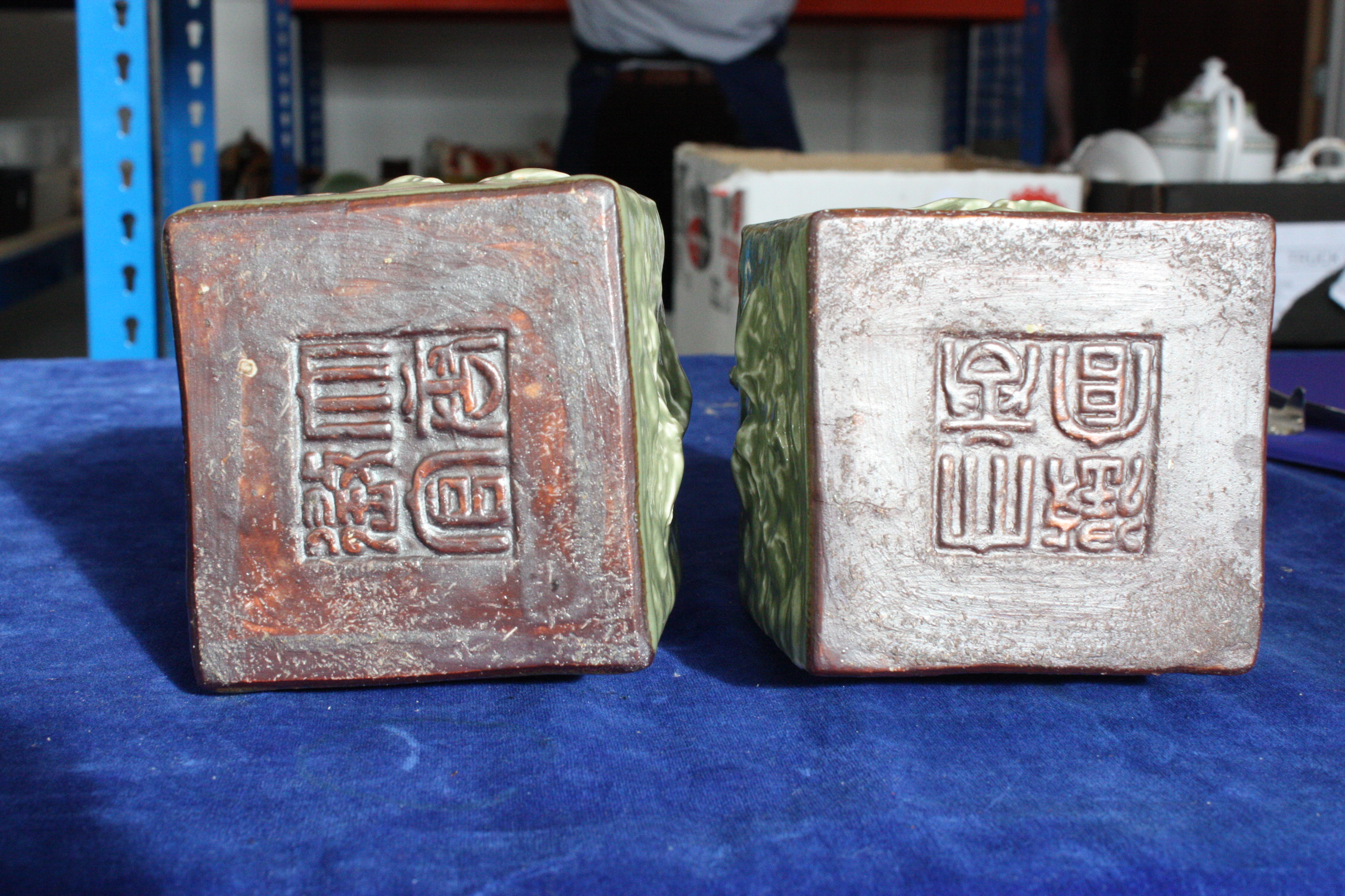 A pair of Chinese celadon glazed scroll weights, with seal marks to underside, decorated with - Image 4 of 7