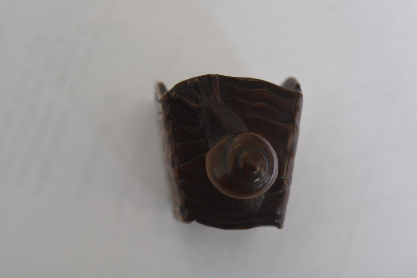 A Meiji period Japanese signed carved wood netsuke, modelled as a gong with large snail to one - Image 5 of 6