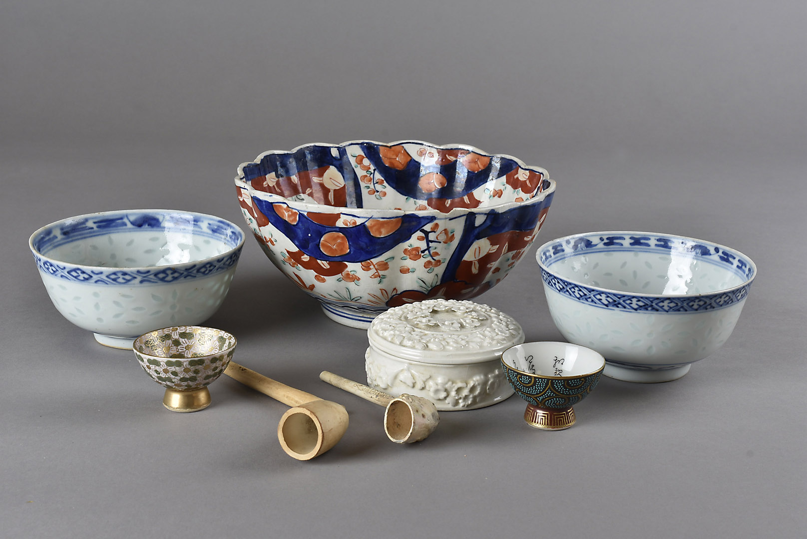 Two Japanese wine flagons, and sake cups, an imari bowl, two Chinese blue and white rice bowls, an