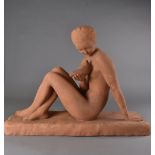 An Art Deco terracotta figure, depicting a female nude with a bird in her hand AF, indistinctly