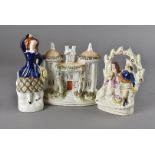 A collection of Staffordshire ceramics, including flatback figures, a spill vase, money box and