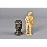 A 19th Century continental carved ivory figure, modelled as a gentleman standing in period dress,