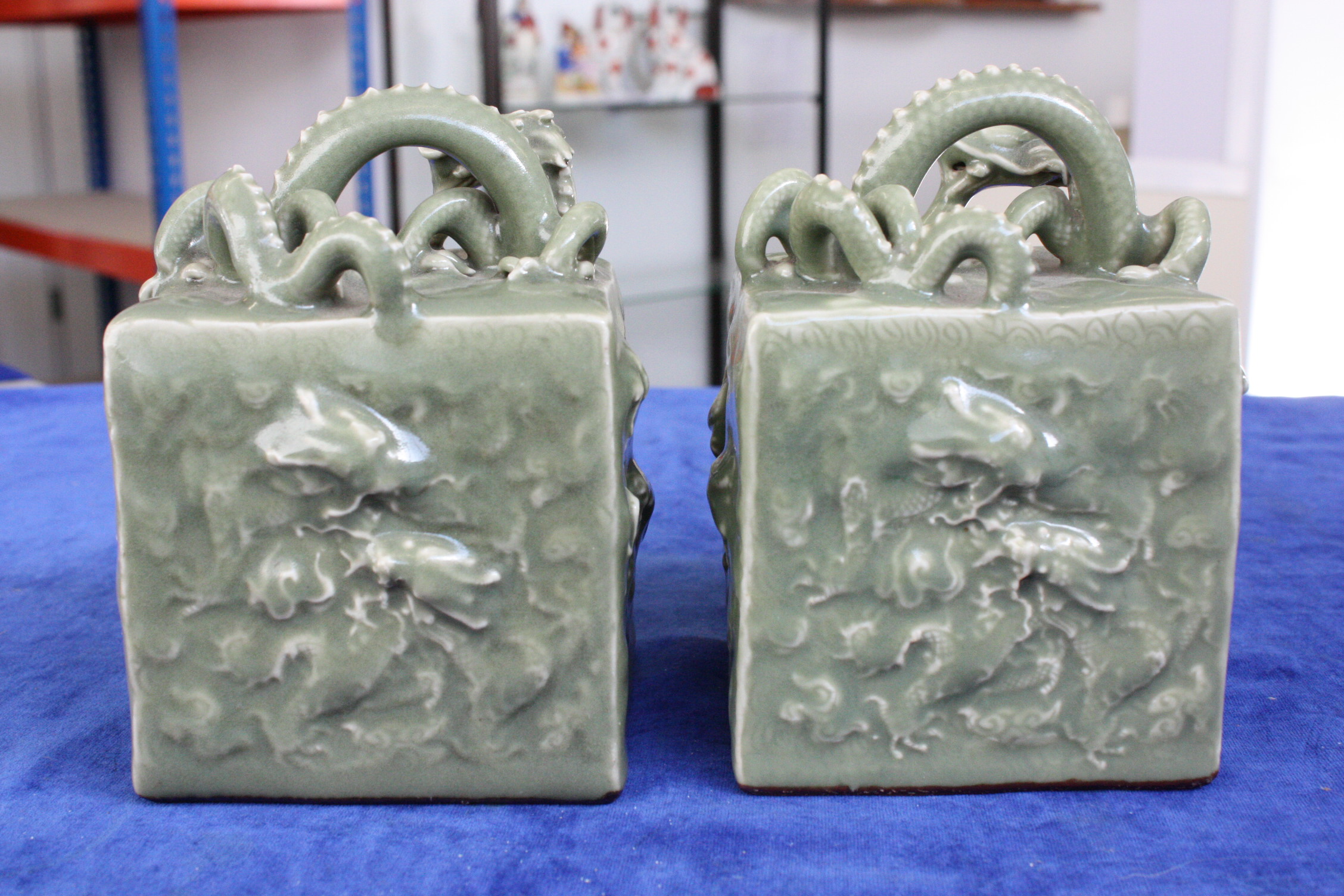 A pair of Chinese celadon glazed scroll weights, with seal marks to underside, decorated with - Image 7 of 7