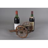 A miniature replica George III six-pounder brass cannon, together with a bottle of 1970 Pauillac,