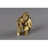 An early 19th Century Japanese signed ivory netsuke, modelled as a gentleman with two water pails