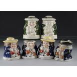 A collection of six novelty tobacco jars with covers, modelled as seated Toby with a jug of