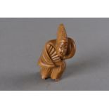 A Meiji period Japanese boxwood carved netsuke, modelled as the dancer Sambaso standing wearing an