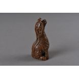A Meiji period signed, carved wooden netsuke, modelled as a seated kirin, the long mane from head to