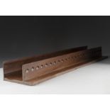 A twenty four hole teak hanging pipe rack, 92 cm long