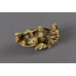 An early 19th Century Japanese carved stag horn netsuke, modelled as Gama Sennin and toad, the