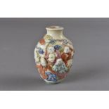 A Chinese porcelain snuff bottles, with relief 'Hundred Boys' decoration, seal marks to the base 7