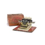 A Gebrüder Schmidt Junior Toy Typewriter, with red tinplate base and cover, circa 1920's, G-VG, some