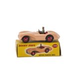 A Dinky Toys 104 Aston Martin DB3S, salmon pink body, red interior and ridged hubs, grey driver,