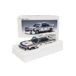 An Autoart Millennium 1:16 Scale BMW 3.00 CSL, in racing white with blue and red stripes, in