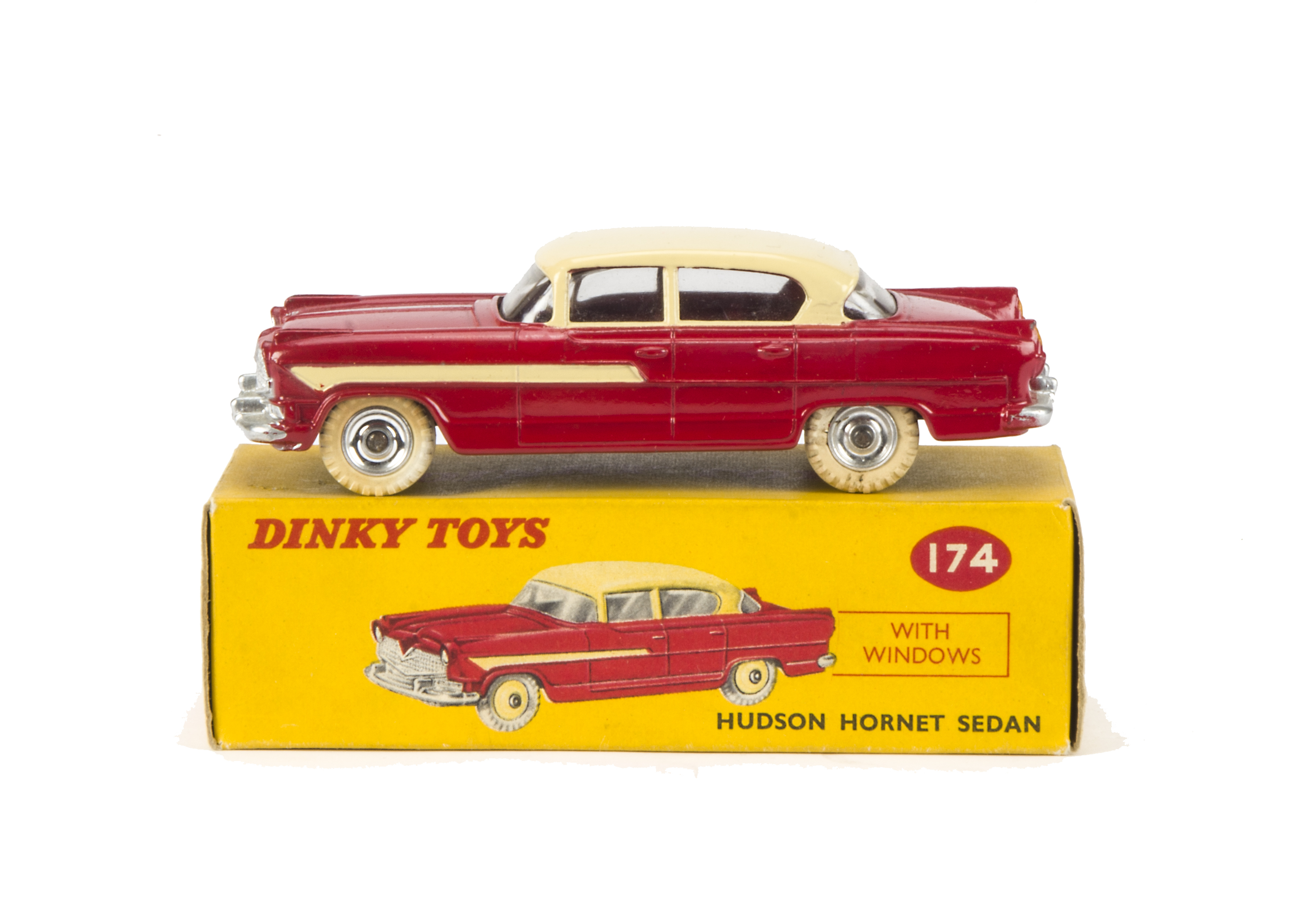 A Dinky Toys 174 Hudson Hornet Sedan, red lower body, cream roof and side flashes, spun hubs, in