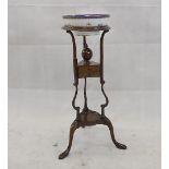 A George III style mahogany tripod washstand, on turned supports with cabriole legs united by